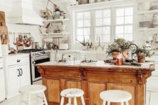 08 a pure white kitchen with a warm-colored vintage kitchen island with a strong rustic feel at the same time