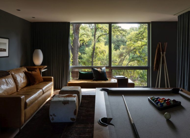 Dark colored walls give this recreational area a cozy and intimate look without fully embracing the rustic style