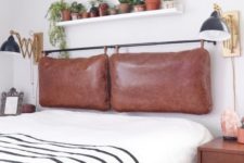 10 a contemporary meets boho bedroom with a brown leather pillow headboard on a black holder