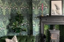11 a moody living room with dark botanical wallpaper, green tiles, a matching sofa and potted plants feels outdoors