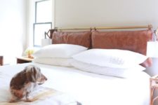 11 a neutral and serene space done with a brown leather pillow headboard on a brass holder that adds color and texture