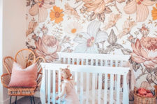 12 a colorful girl’s nursery in peachy and coral with a statement large scale floral print wall that creates a mood here