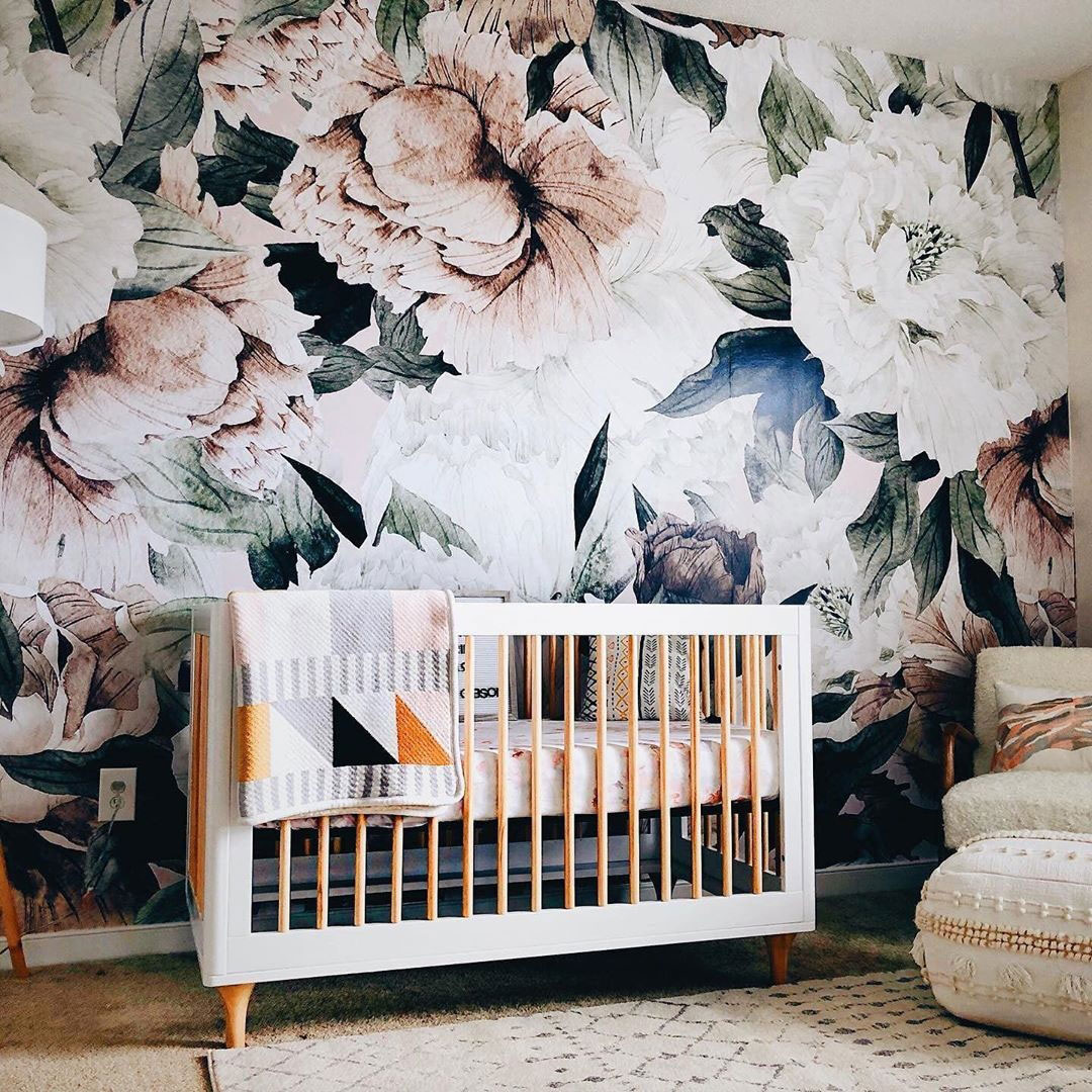 a boho nursery spruced up with a statement realistic floral print wall looks wow