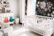 18 a gorgeous kid’s nursery with a refined black realistic floral print wall that stands out in a white space