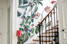 18 a refined entryway with a classic staircase and fantastic bright floral and faune wallpaper plus a little floor lamp in red