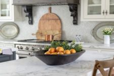 20 a neutral kitchen with white stone countertops and a vintage metal hood in greys to add chic and color