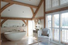 21 a gorgeous refined space with wooden beams and a bathtub zone done with large scale tiles