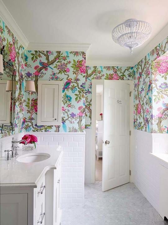 an all neutral bathroom with super bright flora and fauna wallpaper to add a touch of color to the space