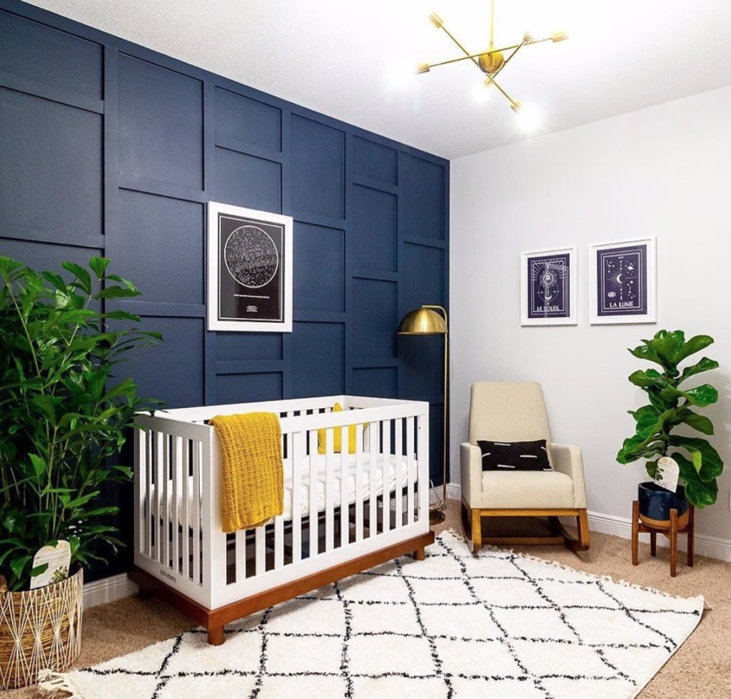 a chic nursery with a navy 3D wall and a navy planter to spice up the neutral space and makes it cooler