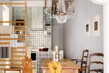 24 an eclectic space with printed tiles, a wooden dining set and a gorgeous crystal vintage chandelier over the space