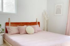 25 a welcoming girlish bedroom with pink bedding and an amber leather headboard hanging