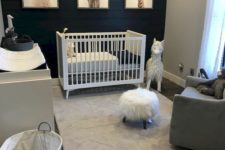26 a chic nursery with a black plank wall and soem white and grey furniture to refresh the room