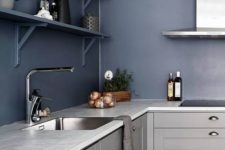 a bold contemporary kitchen in light grey with navy walls and shelves looks ultimately edgy and chic
