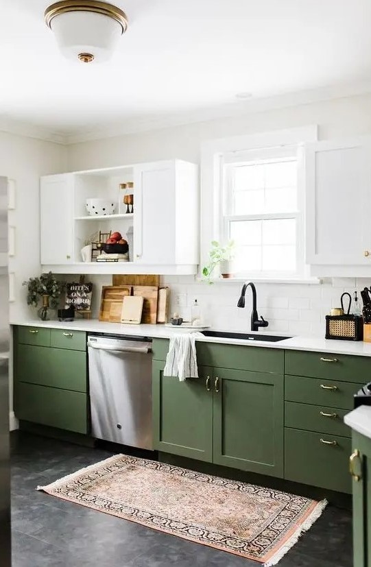 a chic contemporary kitchen with olive green and white cabinets, gold handles and white countertops plus a boho rug