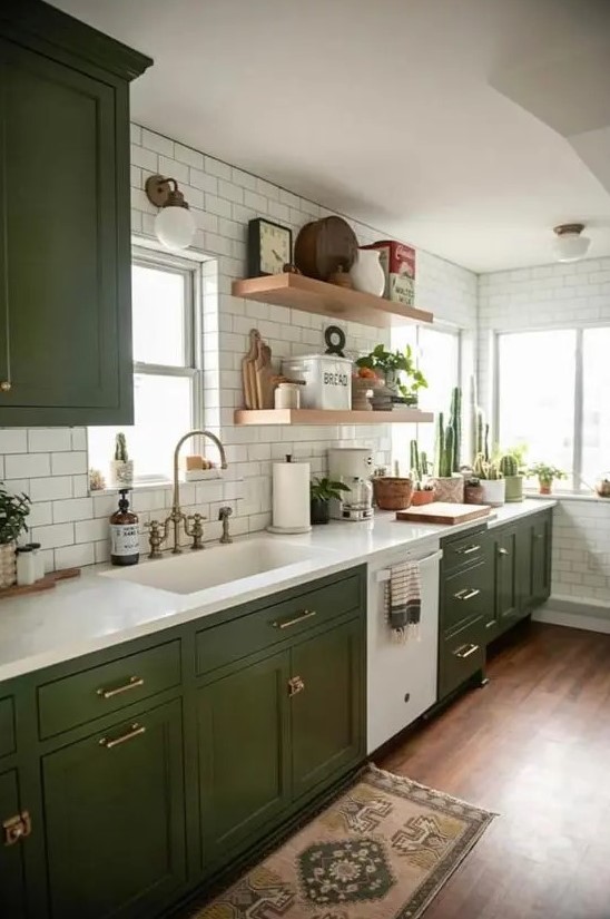 a chic modern meets boho kitchen with olive green shaker cabients, white stone countertops, white subway tiles and open shelves