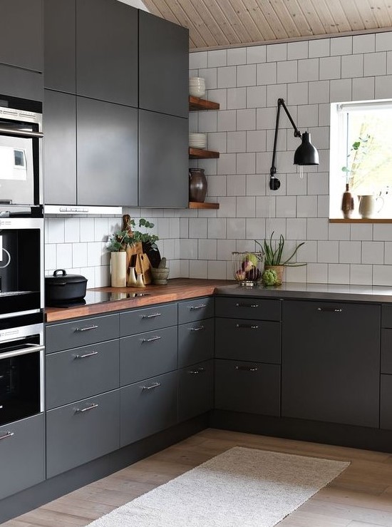 a contemporary graphite grey kitchen with white tiles and rich-colored wooden countertops to refresh