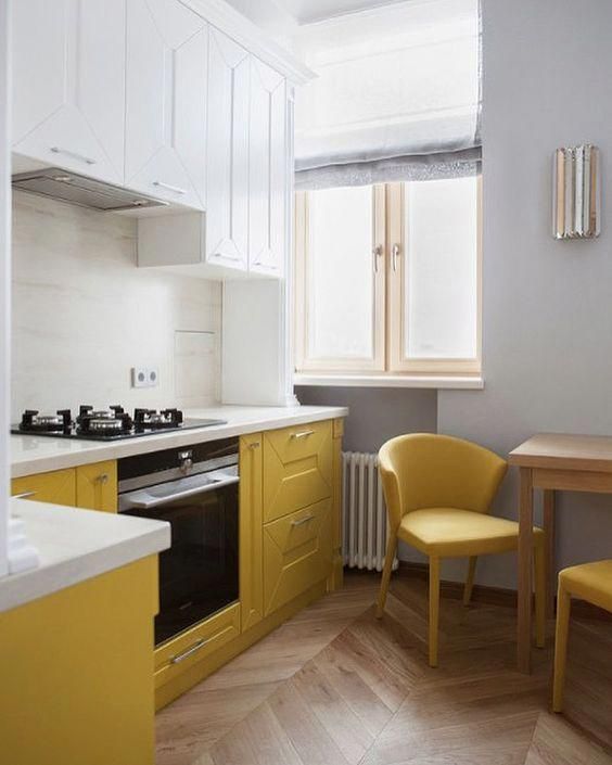 a contemporary kitchen done with white and yellow cabinets with a texture, with white countertops and yellow chairs