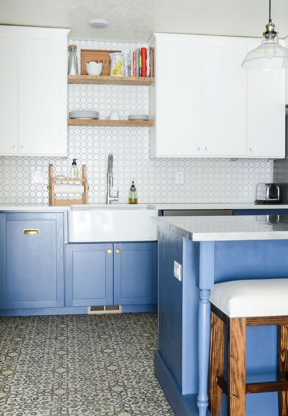 a contemporary kitchen with light blue lower cabinets and white upper ones plus touches of gold