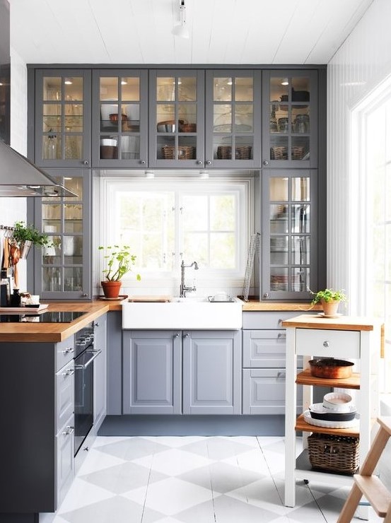 a grey kitchen with wooden countertops and whites and off-whites looks traditional meets modern