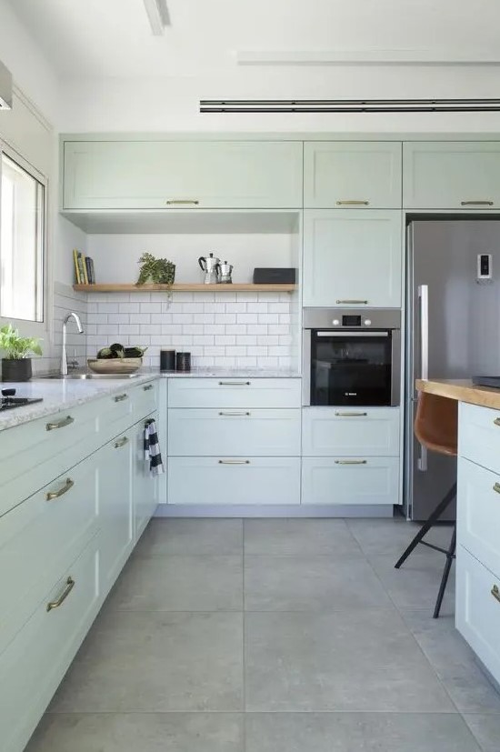 https://www.digsdigs.com/photos/2020/03/a-mint-kitchen-with-shaker-cabinets-white-stone-countertops-and-a-white-subway-tile-backsplash-plus-a-kitchen-island.jpg