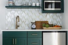 a stylish kitchen with hunter green cabinets, a zig-zag tile backplash and touches of gold for a chic look
