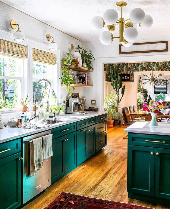 a super bright space with turquoise cabinets, white stone countertops and walls, touches of gold