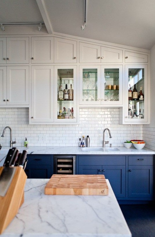 bold blue and white cabinets plus a white subway tile backsplash for a cool look with a touch of retro
