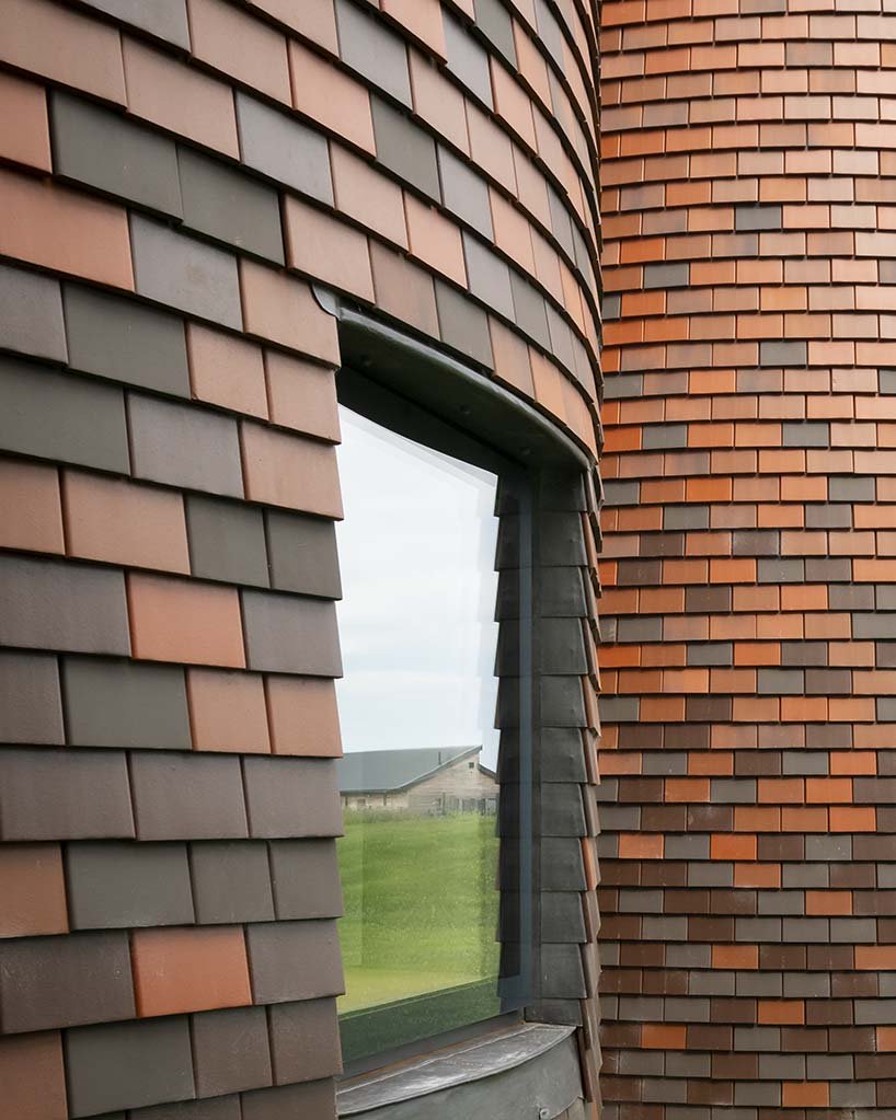 The house is clad with traditional shingle tiles