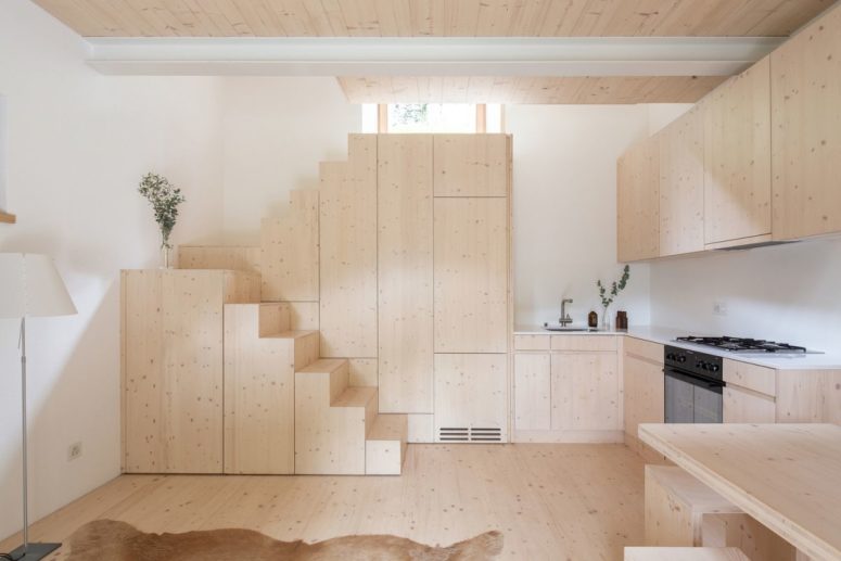 The staircase which connects the common and private areas doubles as a storage unit