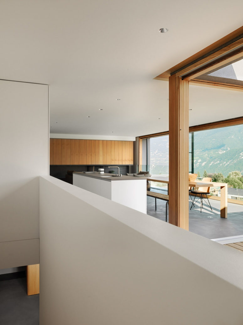 The interiors are done in minimalist style continuing the exterior aesthetics and the decor is very simple and laconic