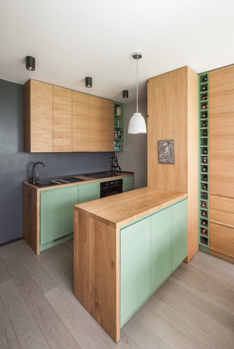 The kitchen features light-colored cabinets and minty green doors - everything necessary is here