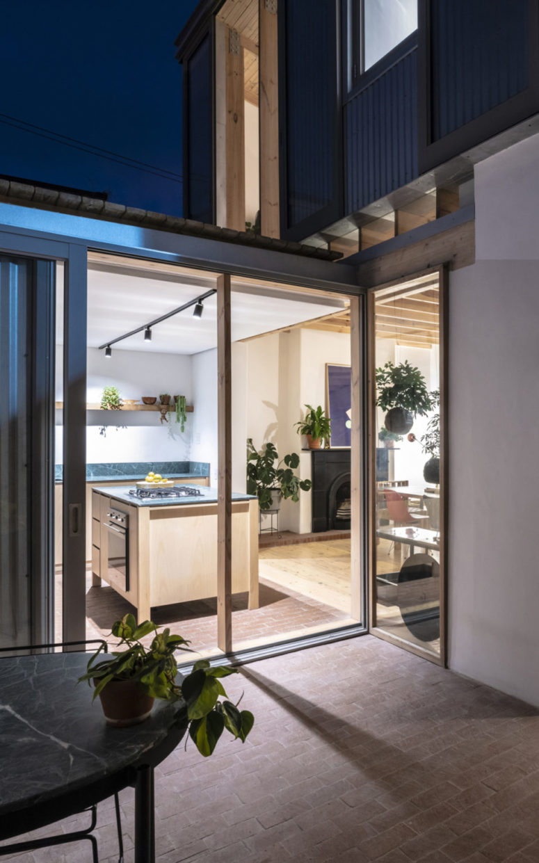 The kitchen is done with neutral MDF cabinets and green stone countertops and can be opened to outdoors The kitchen is done with neutral MDF cabinets and green stone countertops and can be opened to outdoors