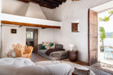 05 The living room is done with comfy neutral upholstered furniture, a wooden trunk chair and bright pillows