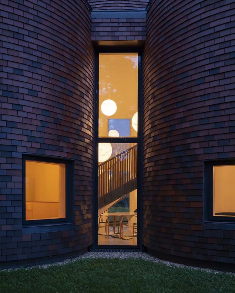 Tall windows fill the spaces with natural light and allow views