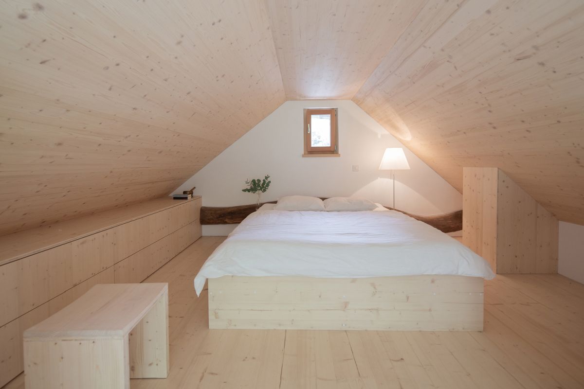 The upstairs area serves as a bedroom and feels a lot like a cozy attic room