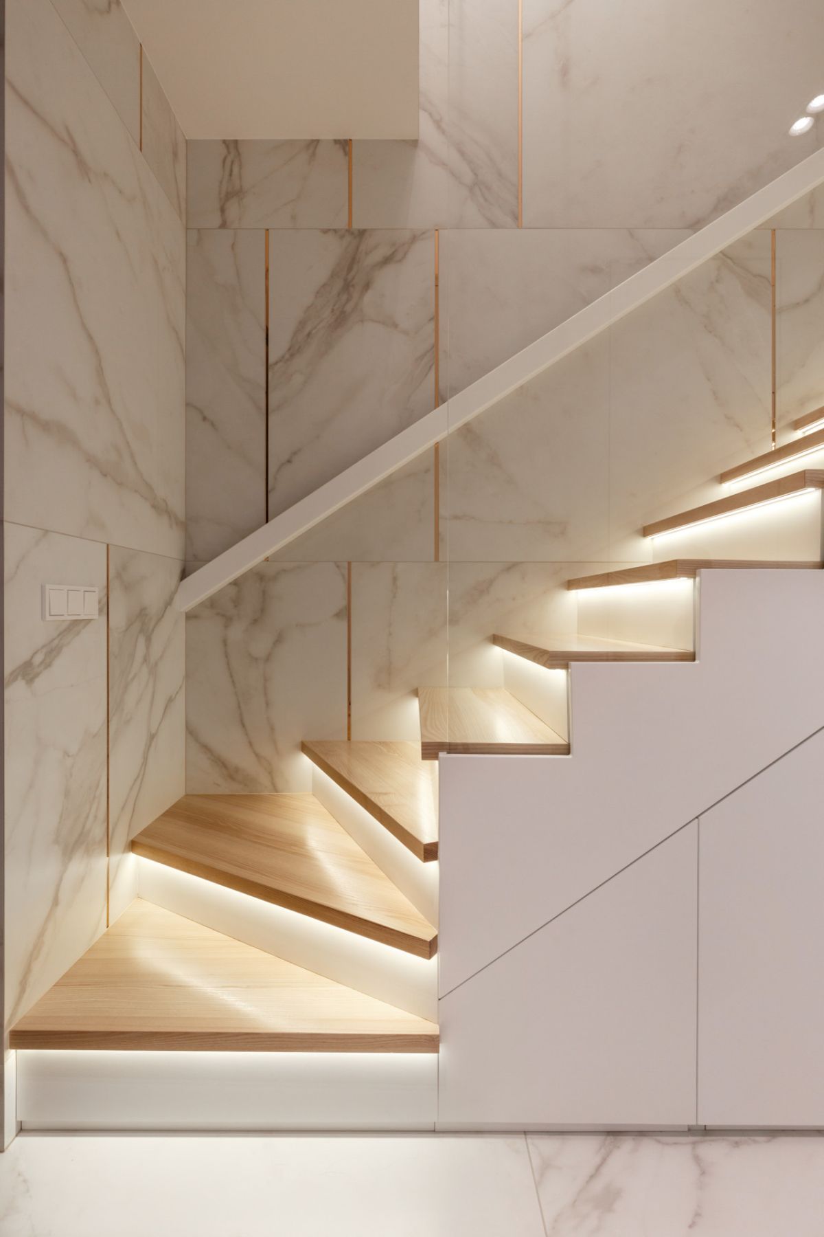 The staircase is very chic, done in white with additional lights