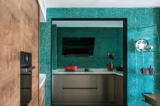 09 The cooking zone is pretty small, with a TV and simple grey cabinets with terrazzo countertops