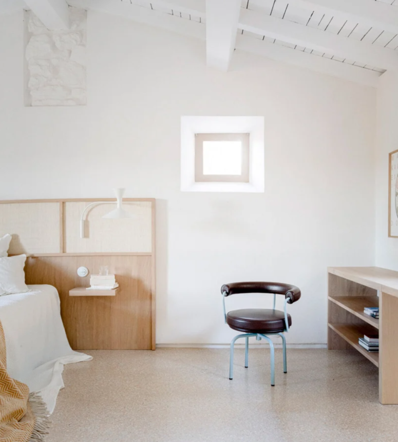 The headboard is very large, with built-in floatign nightstands and sconces attached