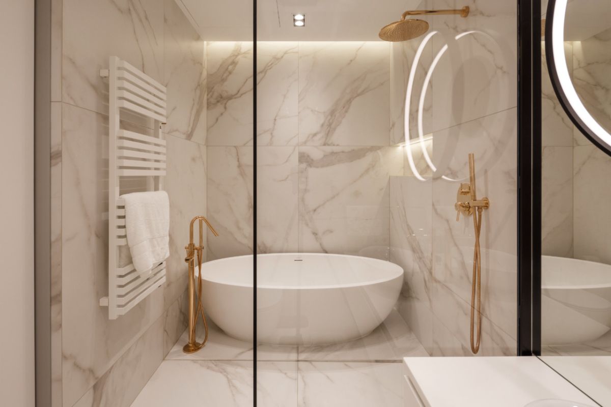 The master bathroom is clad with white marble and has an elegant shower and tub combo