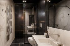 13 The second bathroom is clad with black marble and features a white marble sink and vanity in one
