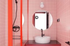 16 a bright modern bathroom with pink tile walls, a fuchsia floating vanity and orange frames is extra bold