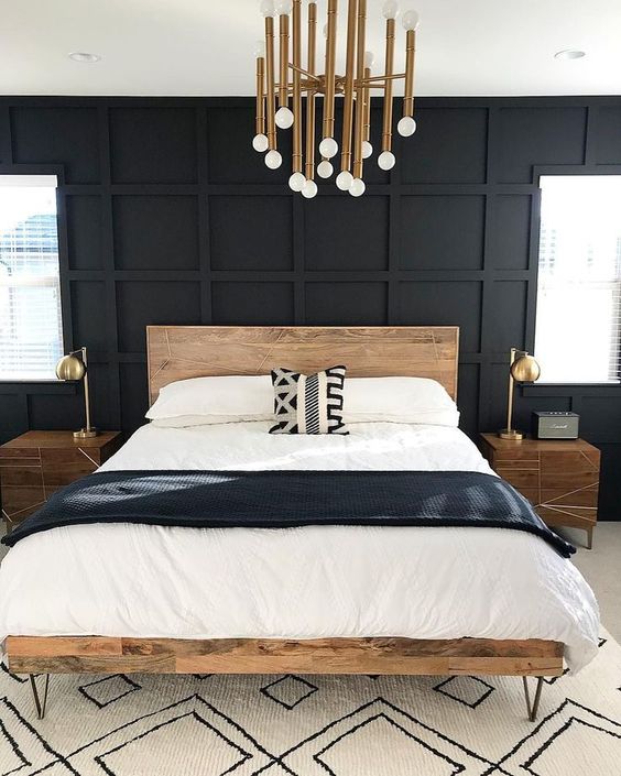 a black statement panel wall makes this neutral bedroom look bold, cool and unusual taking over the space