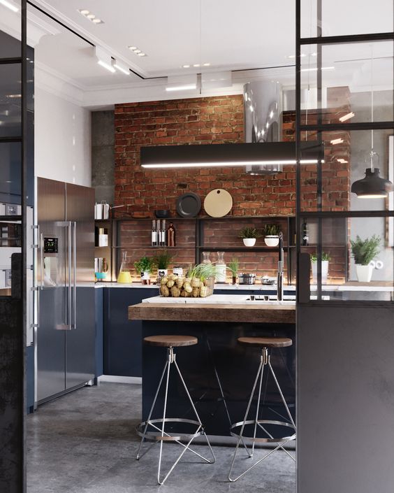 a contemporary navy kitchen with a brick wall, additional lights and pendant lamps plus a shiny metal hood