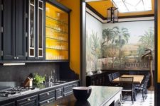 a large vintage kitchen done with yellow walls, black cabinetry and vintage furniture plus lamps makes a statement