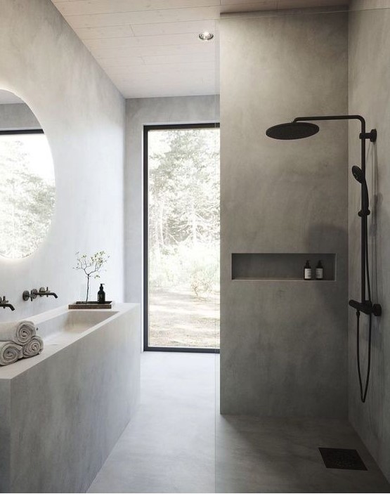 a minimalist concrete bathroom with a built-in vanity and a sink, a shower space, a glazed wall and black fixtures