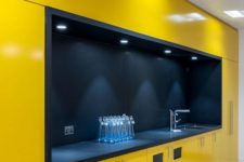 a minimalist yellow kitchen with everything hidden and a large black cooking space with built-in lights looks amazing