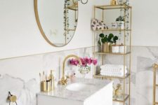 a neutral bathroom with a tall gold etagere, a matching stand and a cool sign on the wall