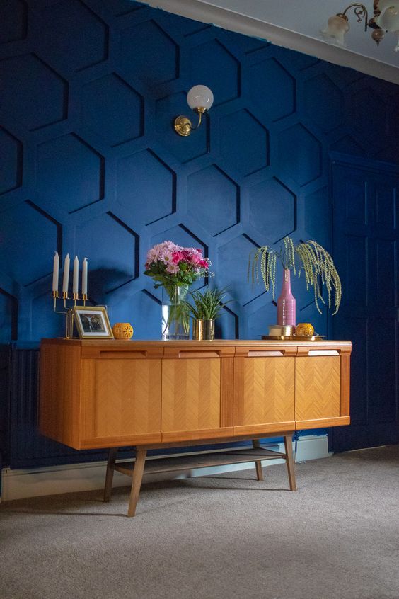 a super bold blue honeycomb paneled statement wall brings both color and pattern to the space to wow