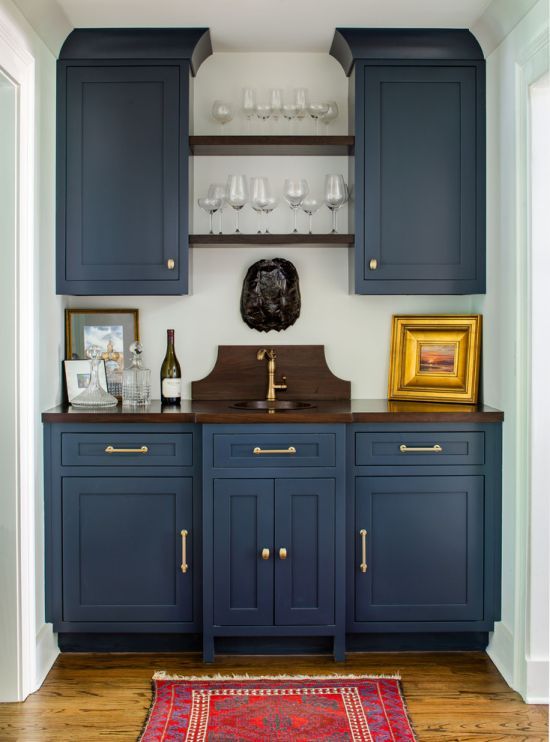 a vintage navy blue kitchen with dark stained wooden countertops and gold handles is a cool and bold idea to rock