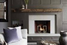a welcoming modern living room with a grey paneled statement wall and a fireplace that stands out a lot